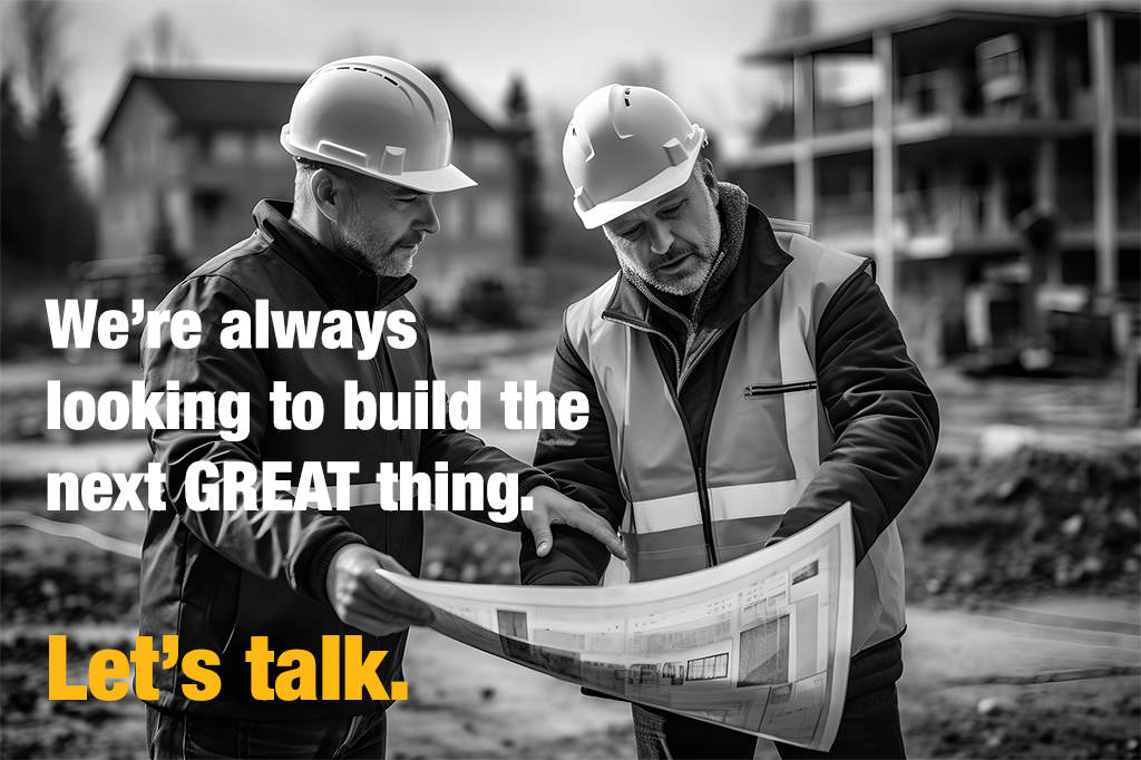 Image of construction workers looking at architectural building plans