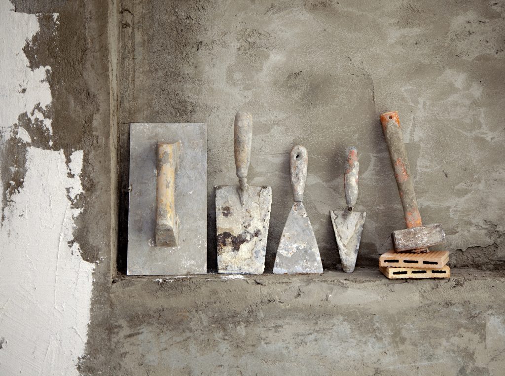 Cement on wall with tools